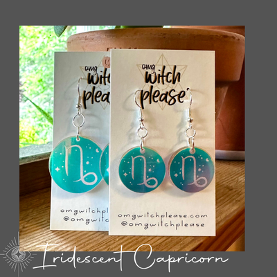 Round Iridescent Acrylic Earrings with an astrological symbol for Capricorn on a business card that says OMG Witch Please