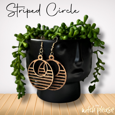 Laser-cut wooden earrings with a striped circular cutout design