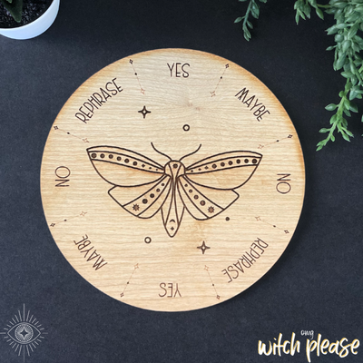 A pendulum board with a moth design