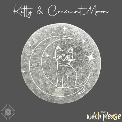 A round selenite plate etched with a design of a kitty sitting on the crescent moon