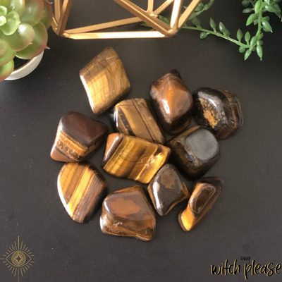 Tigers Eye Tumbled Stones on a table