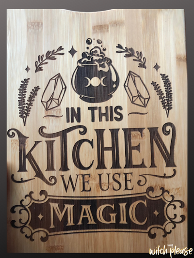 Cutting Board engraved with the words In this kitchen we use magic with witchy illustrations like a cauldron, crystals and herbs