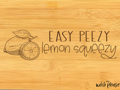 Mockup of bamboo cutting board with a lemon illustration and the words Easy Peezy Lemon Squeezy