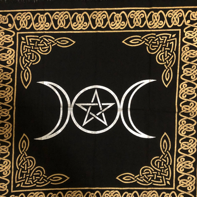 Black altar cloth made of cotton with a silver triple goddess moon design surrounded by a gold celtic braid motif